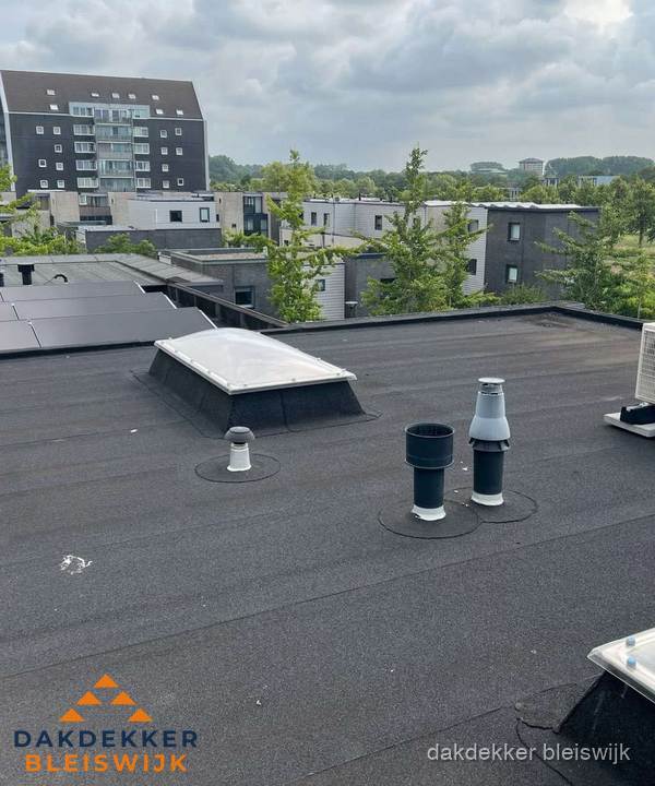 Groot plat dak met lichtkoepel en dakdoorvoeren in Bleiswijk