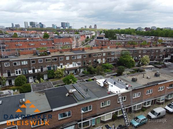 Spoed dakdekker aan het werk op plat dak in woonwijk Bleiswijk