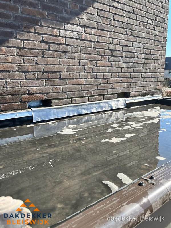 Stilstaand water op plat dak door slechte afwatering in Bleiswijk